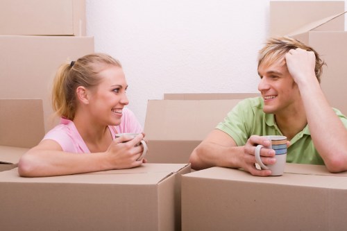 Mover wearing PPE while handling boxes in a property